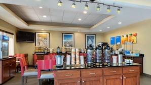 A modern kitchen area with a central island, bar seating, and a coffee station. - Comfort Inn & Suites Port Arthur-Port Neches (Port Arthur)