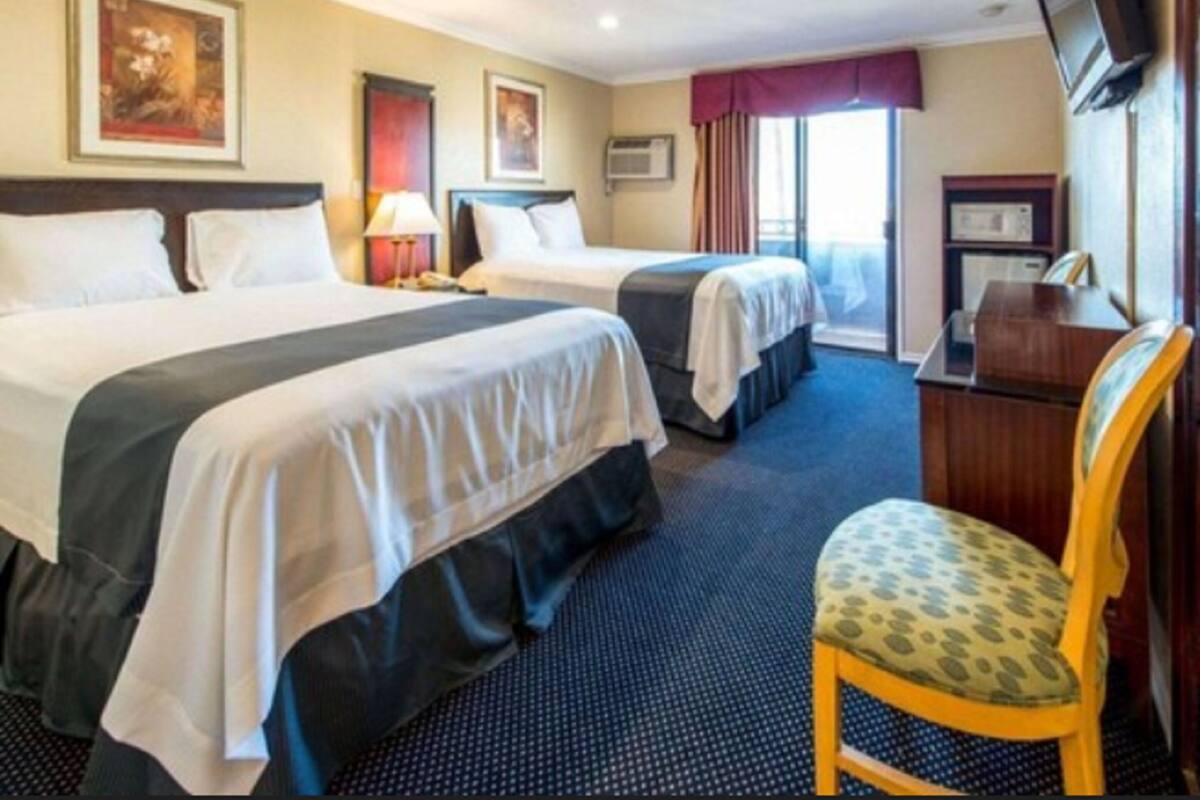 family room, 2 queen beds, refrigerator & microwave, city view | desk, rollaway beds, free wifi