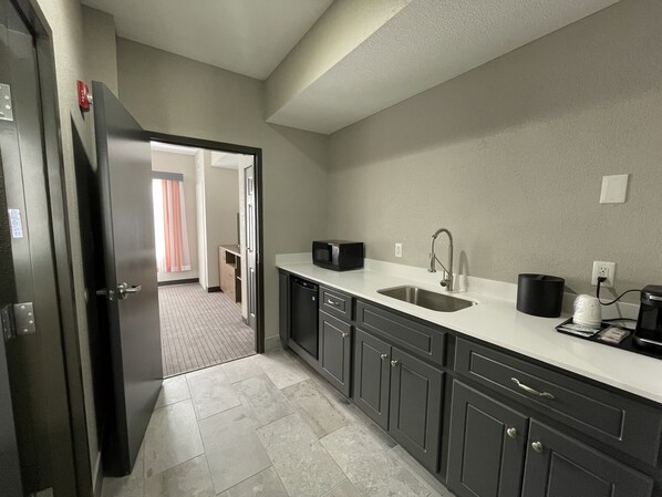 A modern kitchen with a stainless steel sink, a microwave, and a coffee maker. - La Quinta Inn & Suites by Wyndham Augusta/Fort Eisenhower (Augusta)