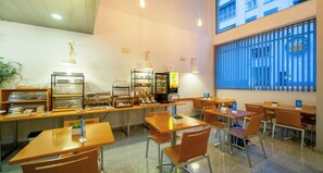 Enjoy meals in a serene dining area with pendant lighting and a view of the outside.