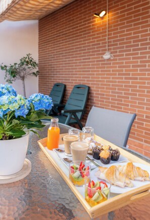 Enjoy a delicious breakfast in our outdoor setting with a tray of fresh pastries, coffee, and juice.