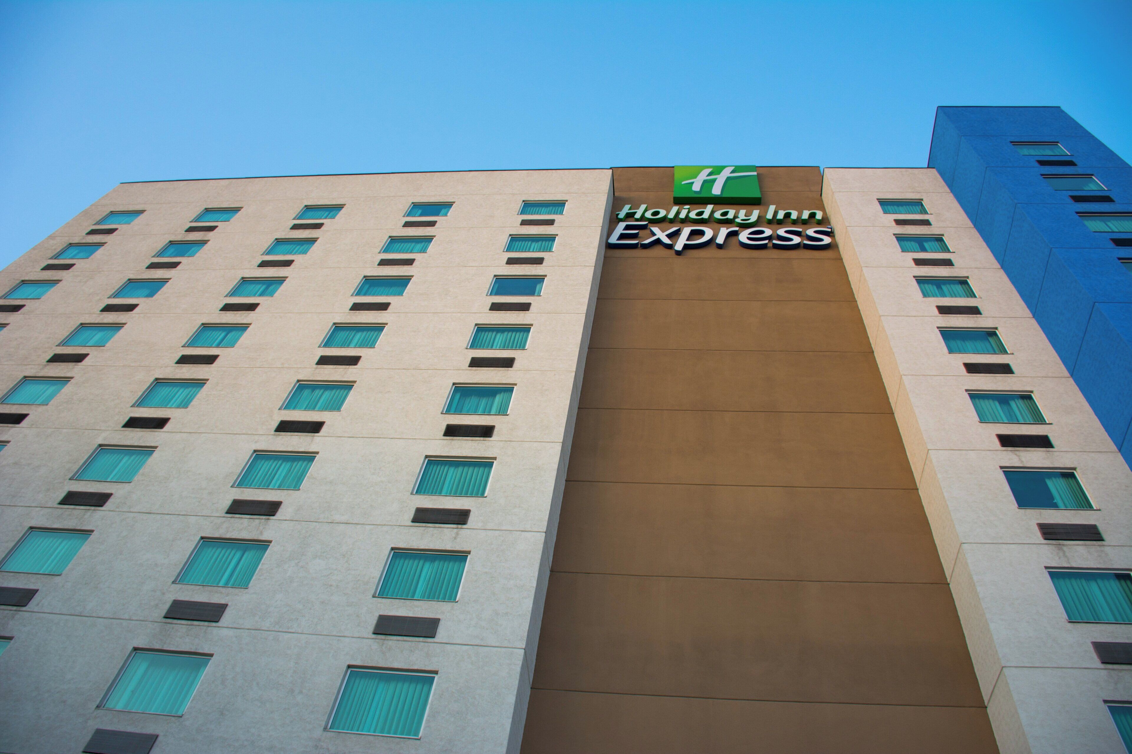 A multi-story building with a prominent sign for Holiday Inn Express.