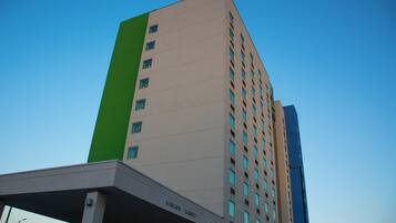 A multi-story building with a flat facade and rectangular windows.