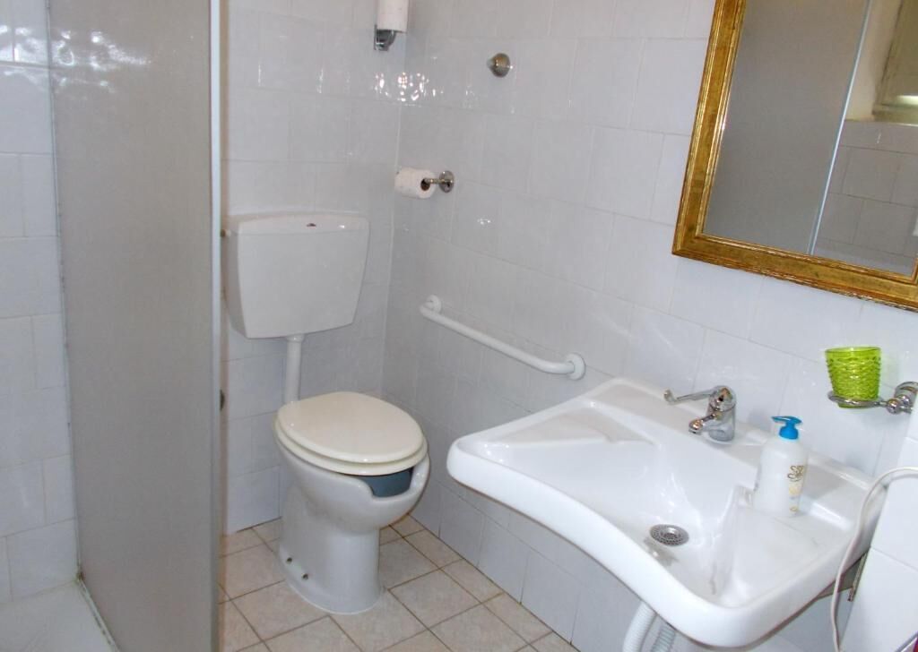 shower, hair dryer, slippers, towels