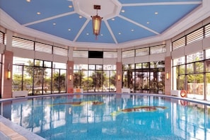 An indoor swimming pool with a high ceiling, large windows, and a central light fixture. - Xiamen Zhongwei Gulangwan hotel (Xiamen)