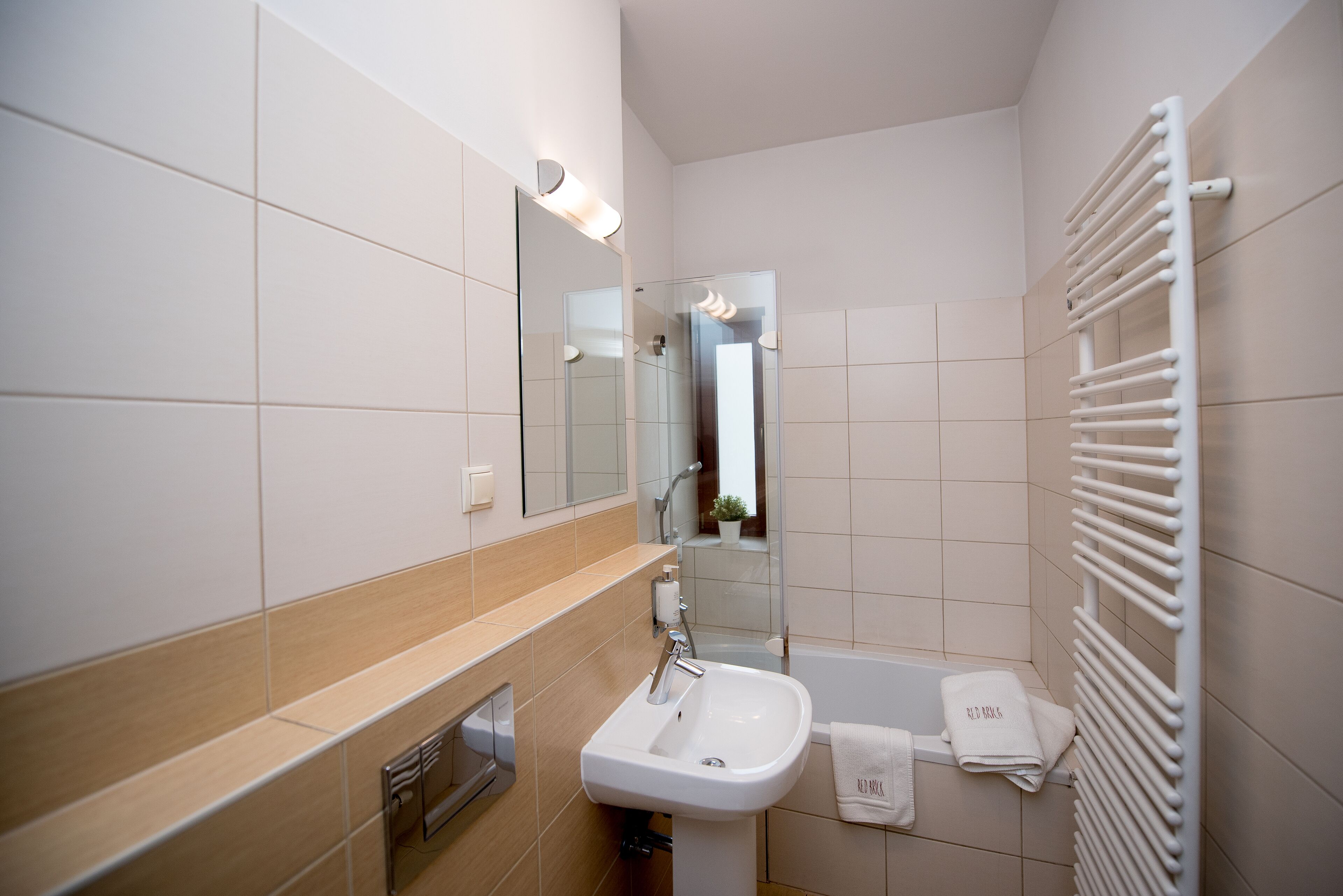 deluxe apartment | bathroom | hair dryer, towels, toilet paper