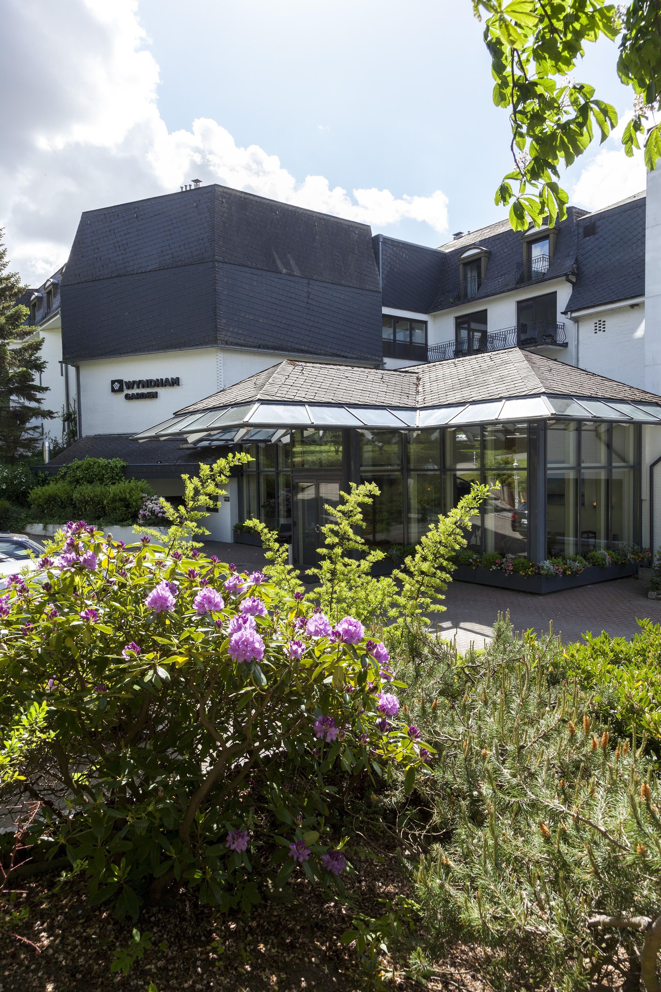 A building with a glass conservatory and a sign that reads "Wyndham Carriage."