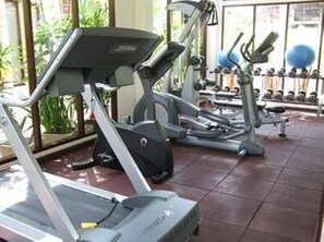 A gym with treadmills, dumbbells, and exercise balls. - The Sarann Koh Samui, Suites & Villas (Koh Samui)