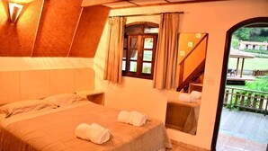 A bedroom with a bed, a window with curtains, a view of a staircase, and a small balcony. - Spazio di Garda (Sao Roque)