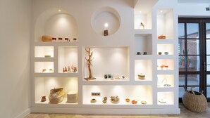 A modern interior with multiple display shelves showcasing various decorative items. - Hotel Club-E (Fethiye)