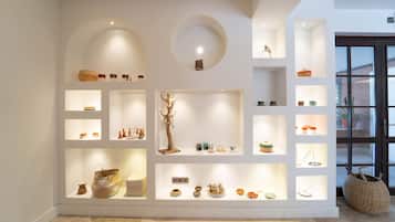 A modern interior with multiple display shelves showcasing various decorative items.