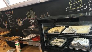 A food display with various items like fries, eggs, and cheese.