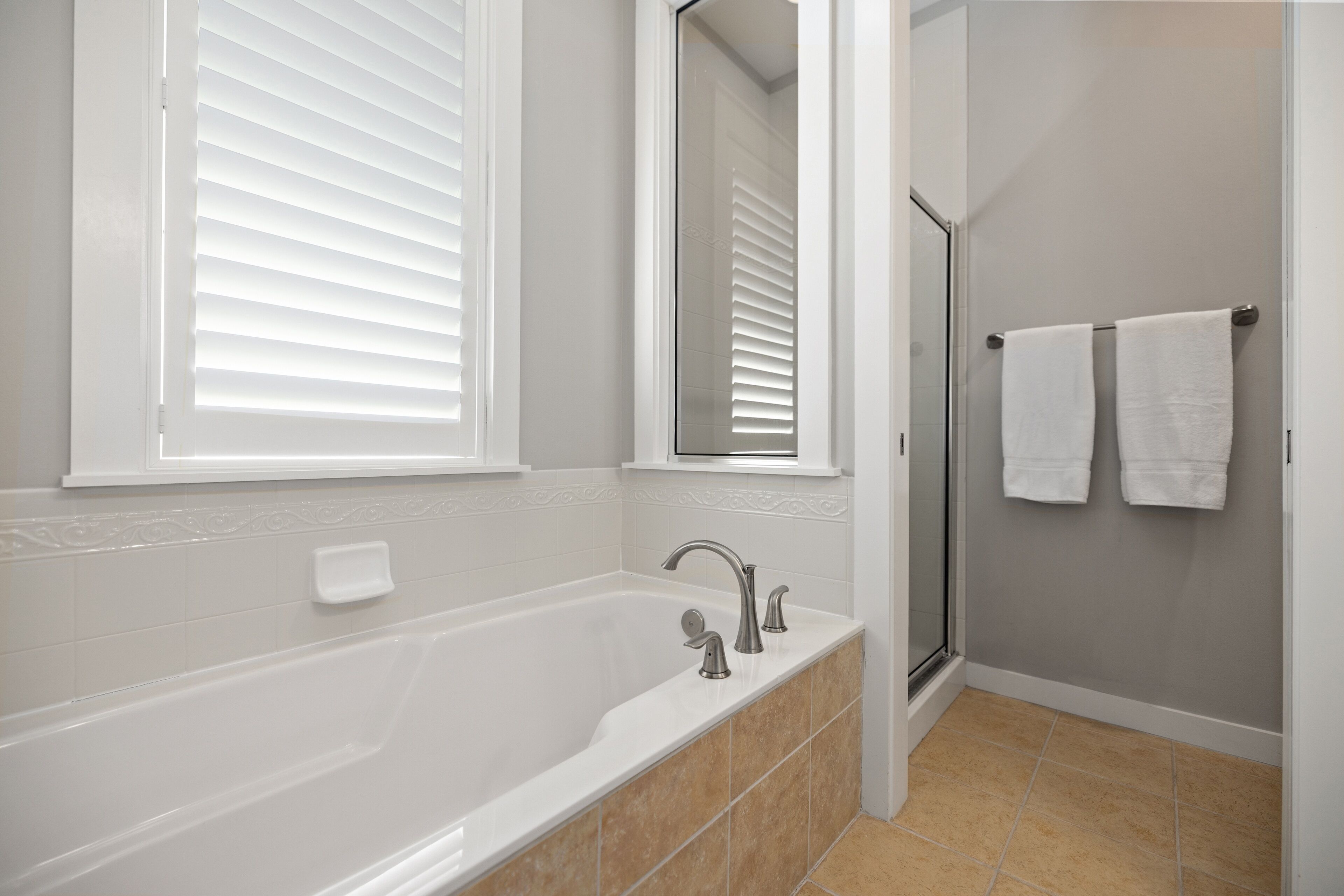 A bathroom with a bathtub, a shower, and a toilet.