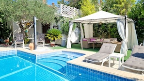A swimming pool with lounge chairs and a covered seating area. - Avalena Residence (Zadar)