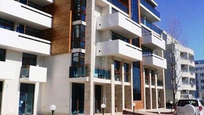 A multi-story residential building with balconies, large windows, and a modern architectural design. - Villa Itta (Sunny Beach)