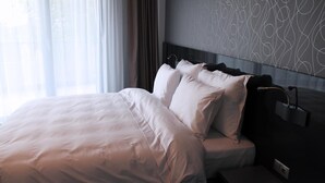 A neatly made bed with white linens in a modern hotel room. - Tempo Hotel Targu Mures (Tirgu Mures)