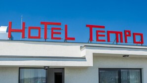 A modern hotel with a clear sign reading 'HOTEL TEMPO' and large glass doors leading to the entrance. - Tempo Hotel Targu Mures (Tirgu Mures)