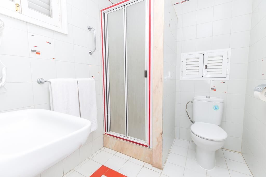 A bathroom with a bathtub, a shower enclosure, and a toilet.