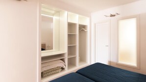 A bedroom with a large wardrobe, a bed, and a window. - Princesa Ico (Tías)