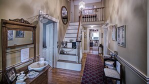A staircase with a chandelier, a mirror, and a sign reading "Private." - Clyde and Marie's Bed & Breakfast (Forest)