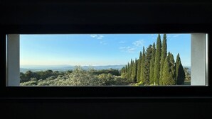 A window with a view of a landscape including trees and distant hills. - Villa with pool between Florence and Arezzo. Magical view  (Loro Ciuffenna (Province of Arezzo))