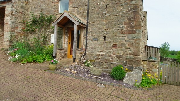 A stone building with a wooden door and a small window. - Pet friendly barn conversion with spectacular views, just for 2. (Crosby Garrett)