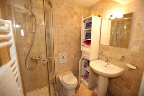 Shower, hair dryer, towels, toilet paper