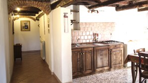 A kitchen with wooden cabinets, a tiled backsplash, and a gas stove.