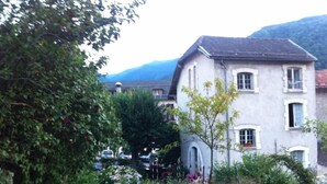 A two-story building with a symmetrical facade, large windows, and a central arched window. - Apartment/ flat - AX LES THERMES (Ax-Les-Thermes)