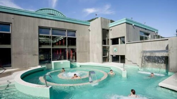 A modern building with a pool area, including a circular hot tub and a separate swimming pool. - Apartment/ flat - AX LES THERMES (Ax-Les-Thermes)