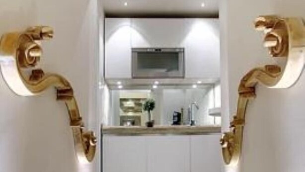 A narrow hallway with a modern kitchen at the end, featuring white cabinets and a stainless steel countertop. - Studio in Piazza Signoria - Internet WiFi, Air Conditioning New 2011 (Firenze)