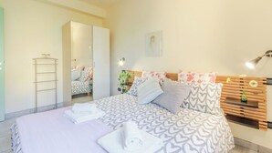 A modern bedroom with a large bed, a wardrobe, and a mirror. - Apartment "Yellow", with pool, Villa Gabriella (Lucca)