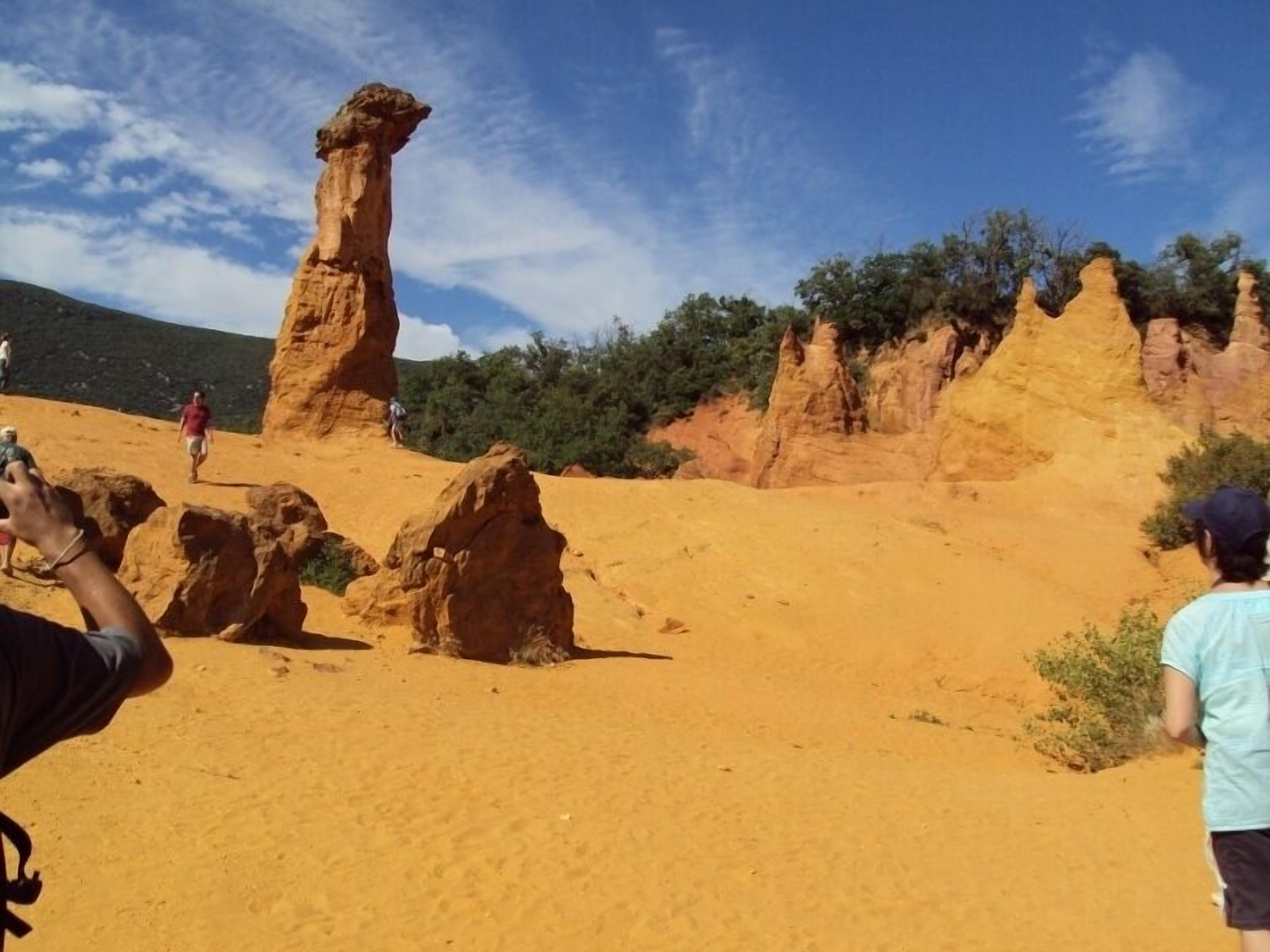 A desert landscape with prominent rock formations and a clear sky.