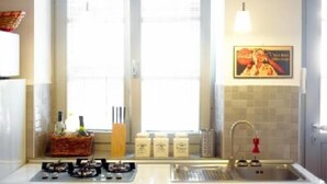 A kitchen with a window, a sink, and a hanging light fixture. - Apartment/ flat -  city center - private parking included (Torino)