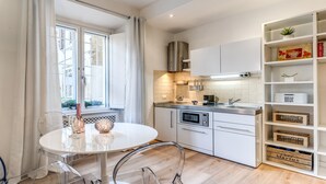 A modern kitchen with white cabinets, a built-in oven, and a window with curtains. - Awesome! Fully renewed,  luxury property *****last minute!! (Roma)