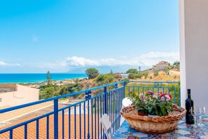Enjoy breathtaking views of the sea and distant mountains from this balcony.