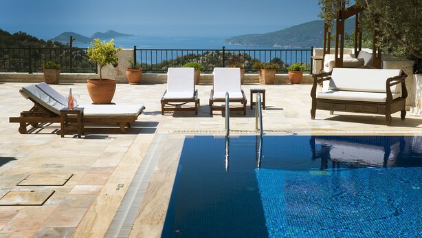 A pool area with lounge chairs and a pergola overlooking a scenic view. - Luxury Kalkan Villa With 2 Pools and Guest House Perfect for Friends or Families (Kalkan)