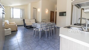 A compact living space with a dining area, kitchenette, and two seating areas. - Exclusive Villa with private salt pool (Case Alte)