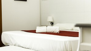 A hotel room with a single bed, white bedding, a red throw blanket, and a bedside lamp. - APARTMENT IN VILLA 200 METERS FROM THE BEACH WI FI CAR RENTAL (Alcamo)