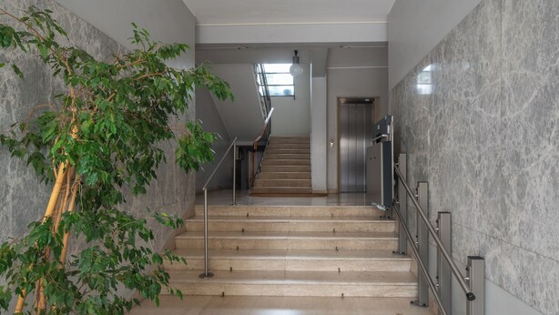 A modern interior with a staircase, marble walls, and a potted plant. - The apartment is an 8-minute walk from Venice/Mestre ferrrov. station. (Venezia)