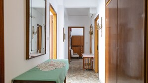A narrow hallway with a wooden table and chairs, a mirror, and a wardrobe. - The apartment is an 8-minute walk from Venice/Mestre ferrrov. station. (Venezia)