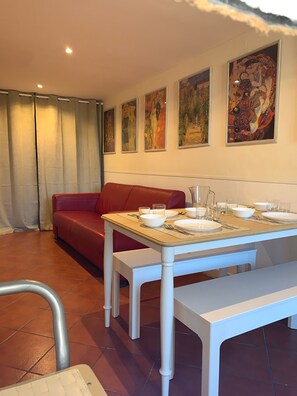 Enjoy meals in this stylish dining area with a comfortable sofa and elegant table setting.