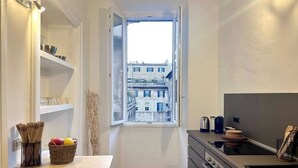 A narrow kitchen with a window, a built-in oven, and a sink. - Rome: HISTORIC CENTER, close to the Pantheon, Trevi Fountain, Piazza di Spagna. (Roma)