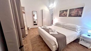 A hotel room with a bed, bedside table, and a mirror. - Rome: HISTORIC CENTER, close to the Pantheon, Trevi Fountain, Piazza di Spagna. (Roma)