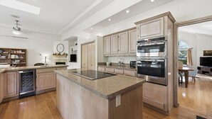 A spacious kitchen with a central island, built-in oven, and a dishwasher. - Beautiful Home, Close to Beach, Lagoon, Fantastic Pool! (Hilton Head Island)