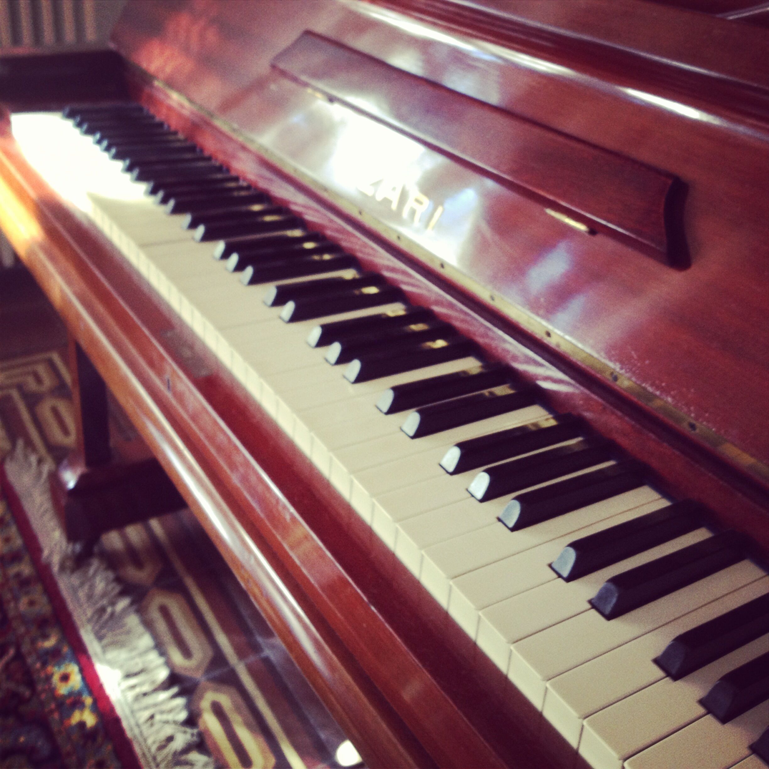 A piano with a glossy finish and a visible brand name on the side.