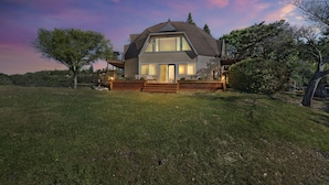 A two-story house with a large front porch, a covered deck, and a well-maintained lawn. - Kid Friendly with Breathtaking Views on 10 Acres (Sonoma)