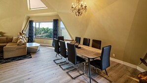 A dining area with a table and chairs, a chandelier, and a view of the outdoors. - Kid Friendly with Breathtaking Views on 10 Acres (Sonoma)