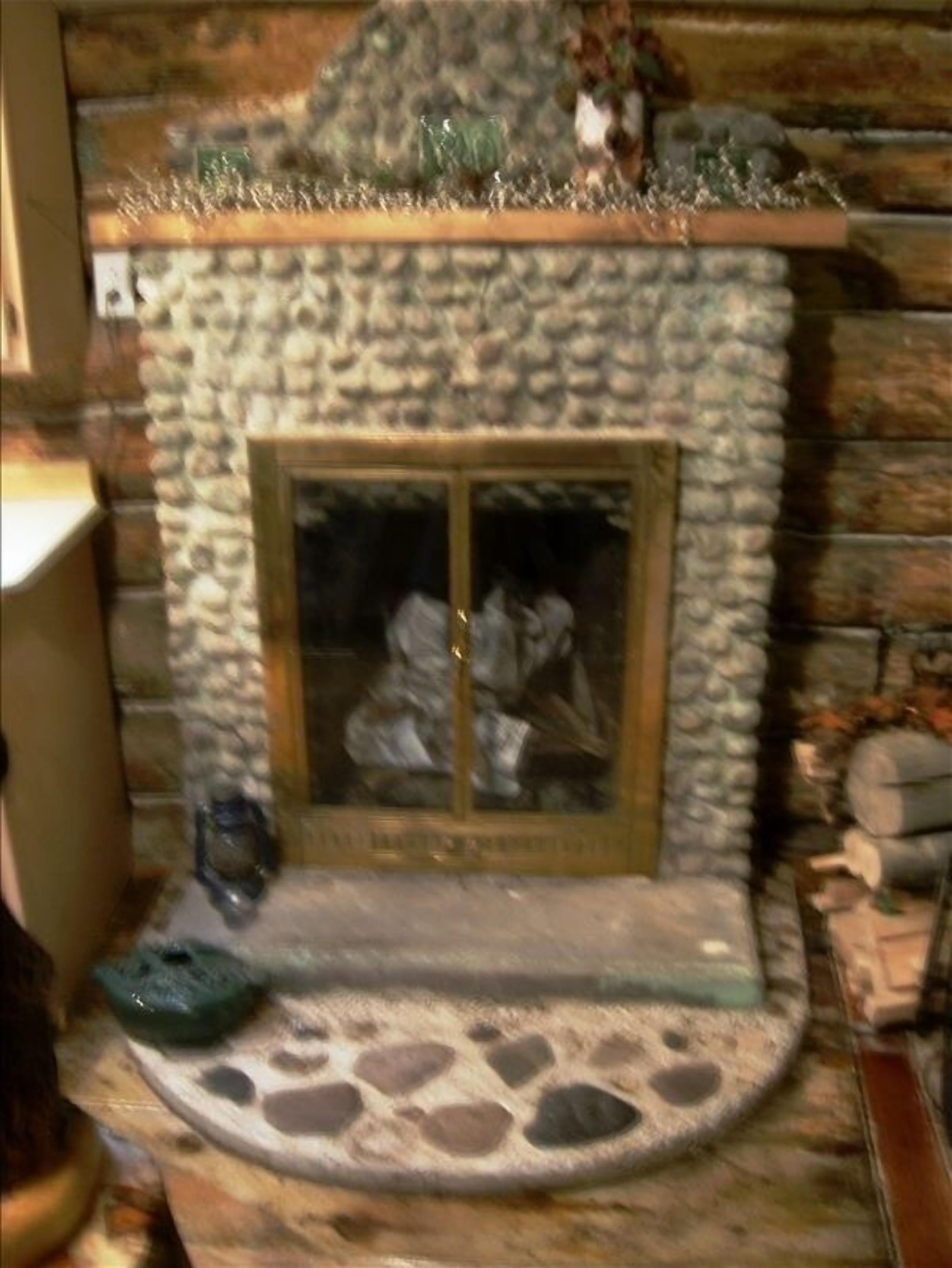 A stone fireplace with a glass door, surrounded by a stone hearth and a small decorative item on the mantel.