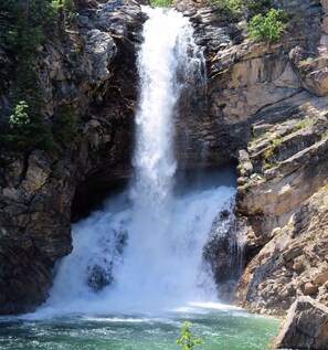 A waterfall cascading down a rocky cliff into a pool of water. - Welcome to the Farmer's Inn (Browning)
